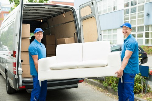 Movers team preparing a safe relocation with boxes and protective equipment