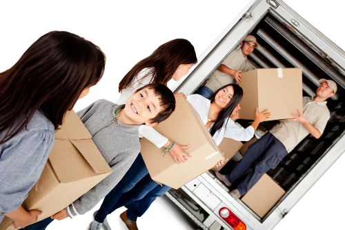 Student moving boxes and furniture in Paddington street setting