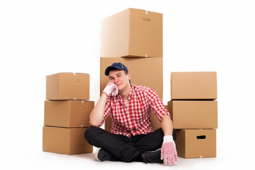 Professional movers handling boxes and furniture in a Paddington apartment building